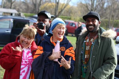 A group of people laughing and smiling for the camera